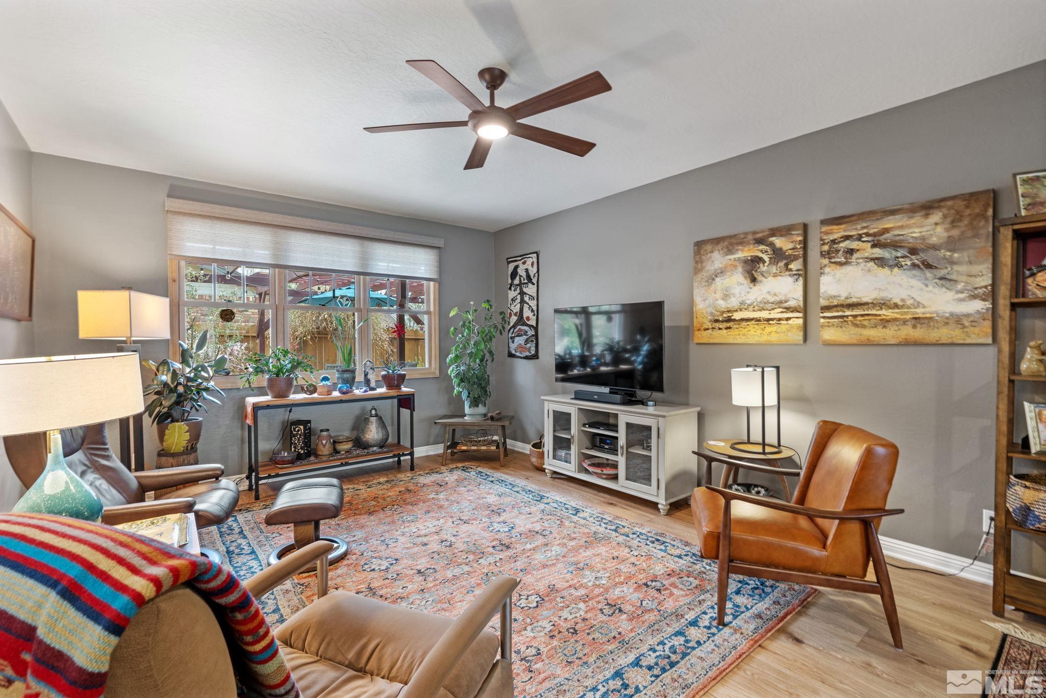 690 Shamrock Lane Reno, NV 89509 - Photo 8 of 30 a living room with furniture a flat screen tv and a large window