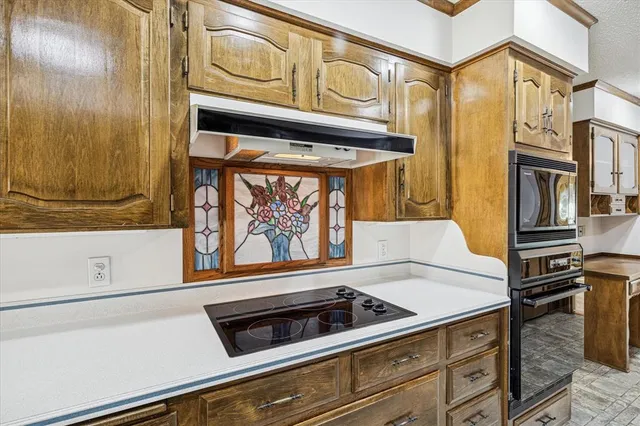 a stove top oven sitting inside of a kitchen
