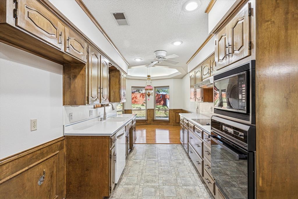 805 Newport Road Fort Worth, TX 76120 - Photo 13 of 27 a kitchen with counter top space and stainless steel appliances
