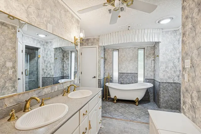 a spacious bathroom with a sink a toilet a mirror and shower