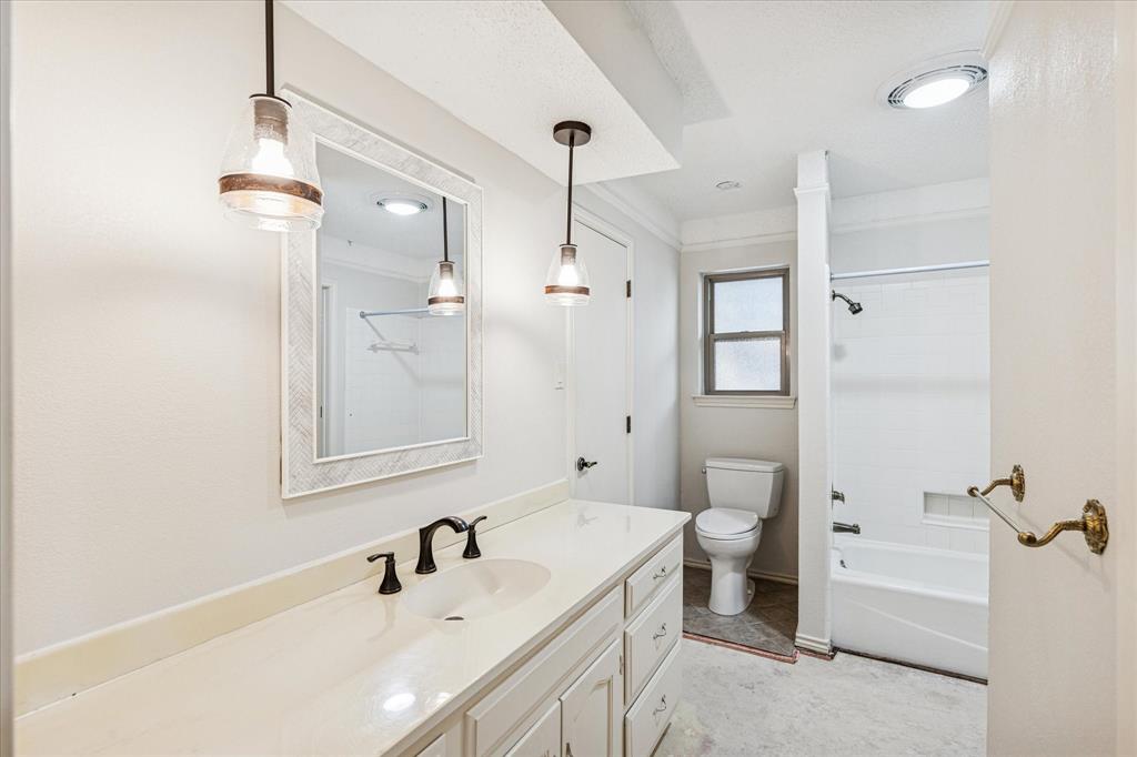 805 Newport Road Fort Worth, TX 76120 - Photo 22 of 27 a bathroom with a sink and a mirror