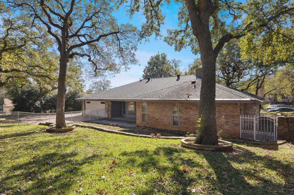 805 Newport Road Fort Worth, TX 76120 - Photo 25 of 27 a view of a yard with a tree