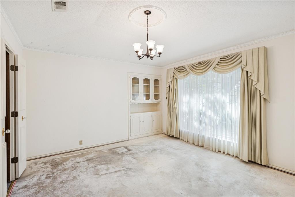 805 Newport Road Fort Worth, TX 76120 - Photo 6 of 27 a view of a chandelier in big room and windows