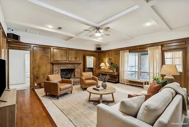 a living room with furniture ceiling fan and a fireplace