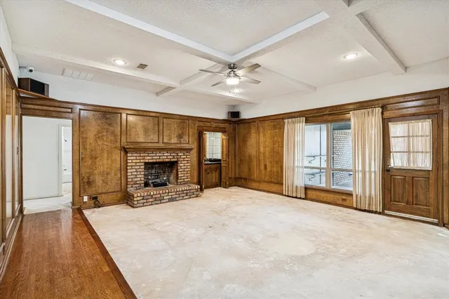 a view of an empty room with a fireplace and a large window
