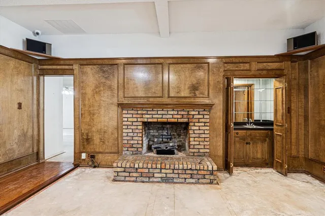 an empty room with fireplace and windows