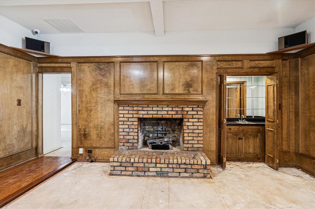 805 Newport Road Fort Worth, TX 76120 - Photo 9 of 27 an empty room with fireplace and windows