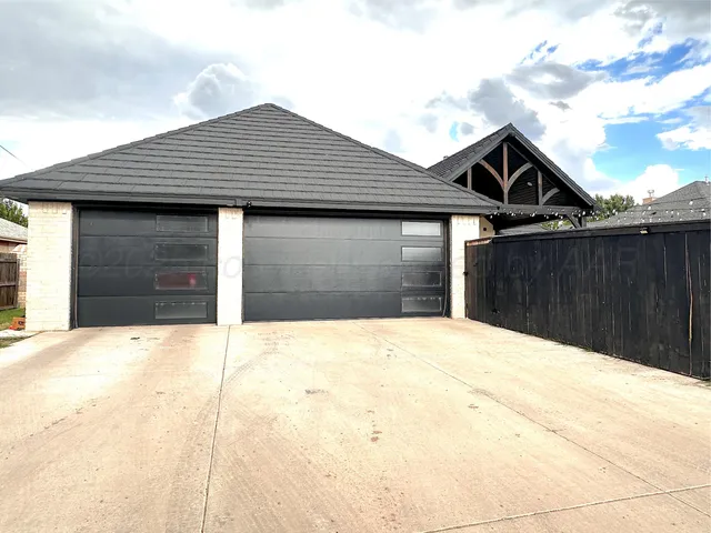 a backyard of a house with wooden fence