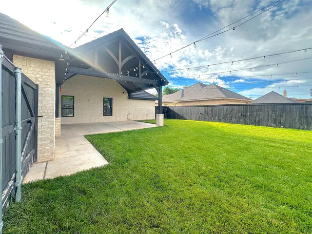 a view of a front of a house with a yard