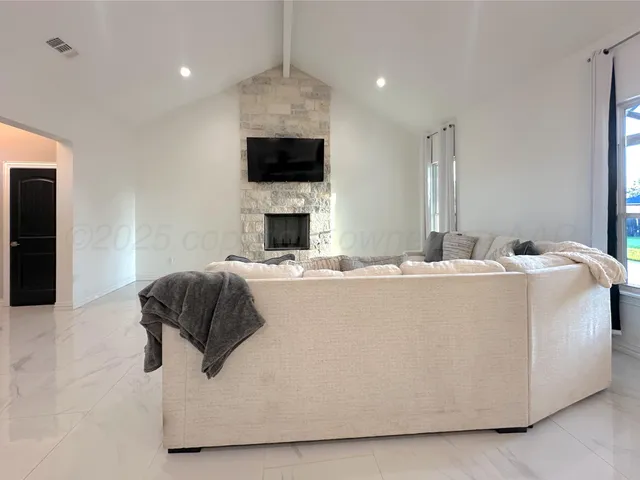 a living room with furniture and a fireplace