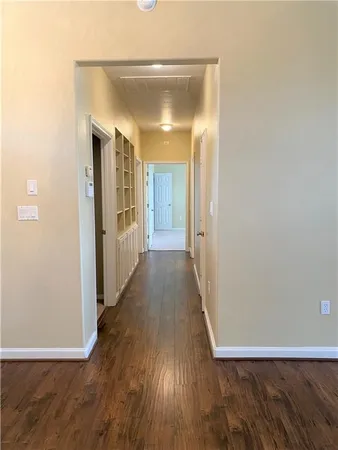 a view of a hallway with wooden floor