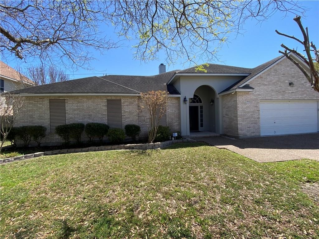 7814 Regal Street Corpus Christi, TX 78413 - Photo 2 of 35 a front view of a house with garden