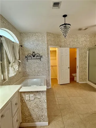 a bathroom with a granite countertop sink a large mirror and shower