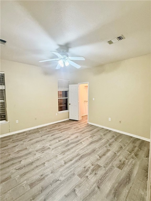 7814 Regal Street Corpus Christi, TX 78413 - Photo 25 of 35 en empty room with wooden floor and fan