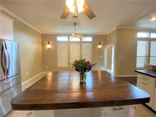 a view of kitchen with refrigerator and window