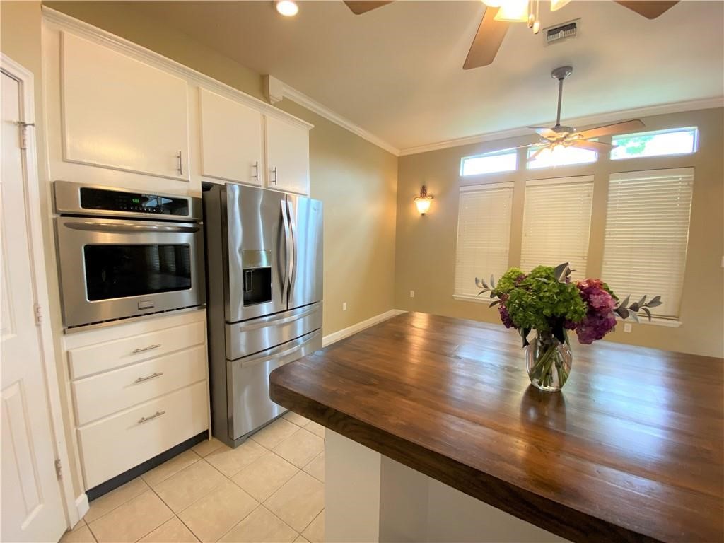 7814 Regal Street Corpus Christi, TX 78413 - Photo 8 of 35 a kitchen with stainless steel appliances a microwave a stove and refrigerator