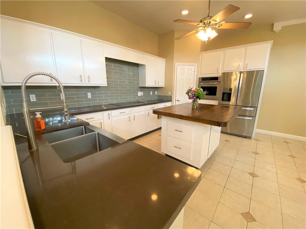 7814 Regal Street Corpus Christi, TX 78413 - Photo 10 of 35 a kitchen with stainless steel appliances granite countertop a sink a stove and a refrigerator