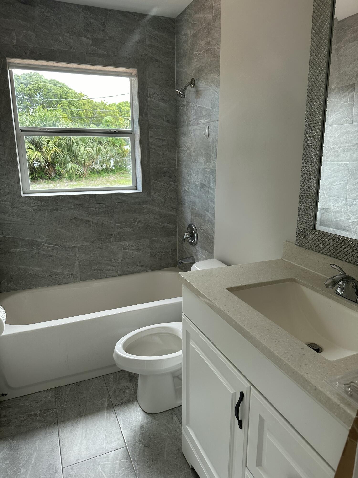 1092 Florence Road Lantana, FL 33462 - Photo 9 of 15 a bathroom with a sink a toilet and a bathtub