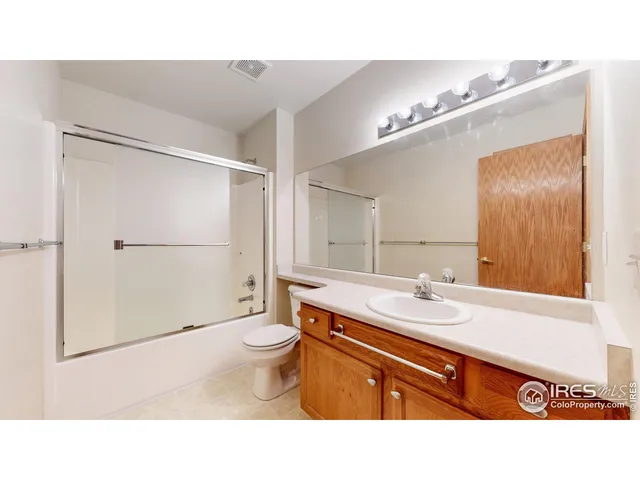 a open hall with a window and a ceiling fan