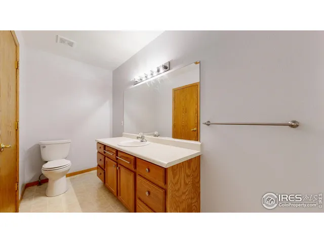 a bathroom with a sink a toilet and mirror