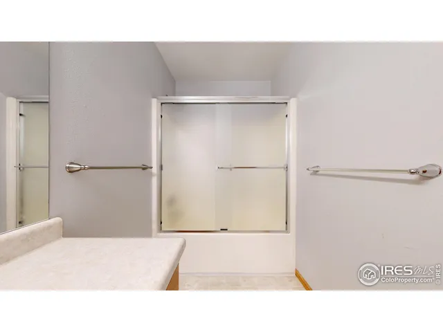 a bathroom with a shower and a sink