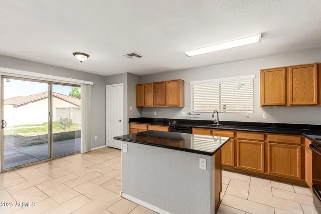 a kitchen with granite countertop a sink and a stove