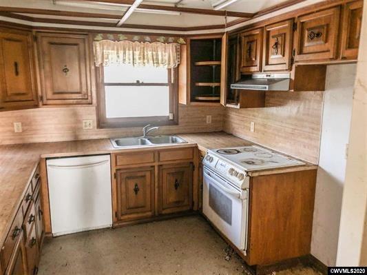 8220 Wallace Road Northwest Salem, OR 97304 - Photo 9 of 23 a kitchen with stainless steel appliances granite countertop a stove and a sink