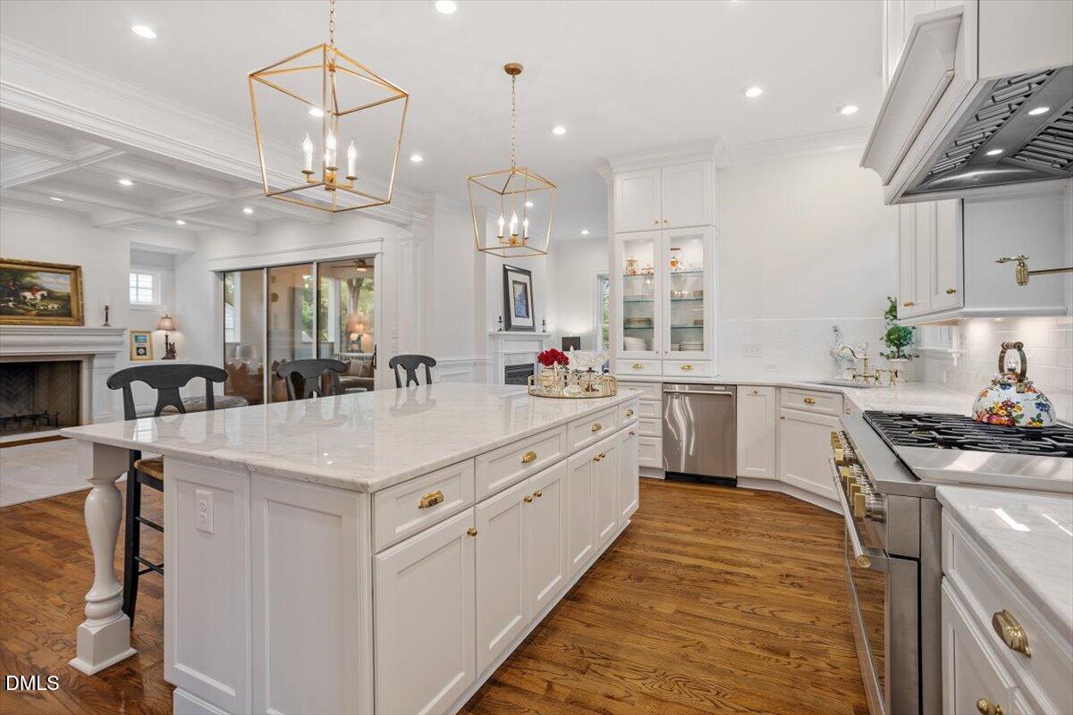 1713 Oberlin Road Raleigh, NC 27608 - Photo 18 of 53 a large white kitchen with kitchen island a stove a sink a oven and a dining table