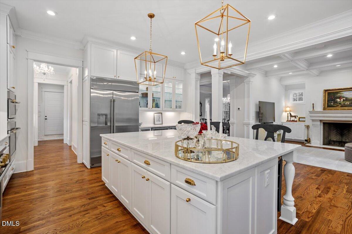 1713 Oberlin Road Raleigh, NC 27608 - Photo 20 of 53 a large kitchen with kitchen island a stove a sink a center island and wooden floor