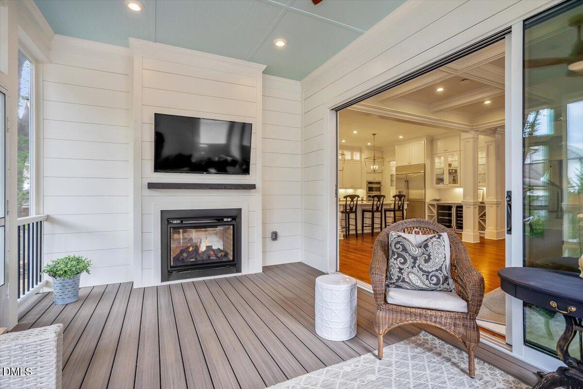 1713 Oberlin Road Raleigh, NC 27608 - Photo 25 of 53 a living room with furniture a flat screen tv and a fireplace