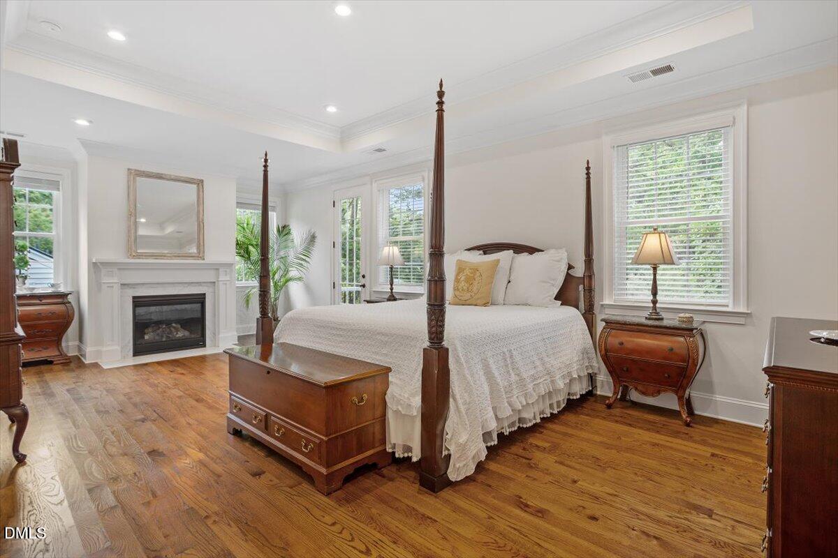 1713 Oberlin Road Raleigh, NC 27608 - Photo 28 of 53 a spacious bedroom with a bed and a fireplace