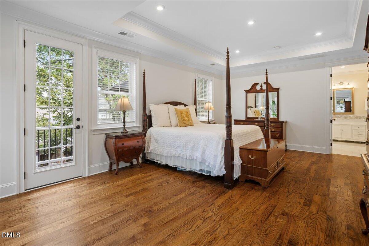 1713 Oberlin Road Raleigh, NC 27608 - Photo 29 of 53 a bedroom with a bed window and wooden floor