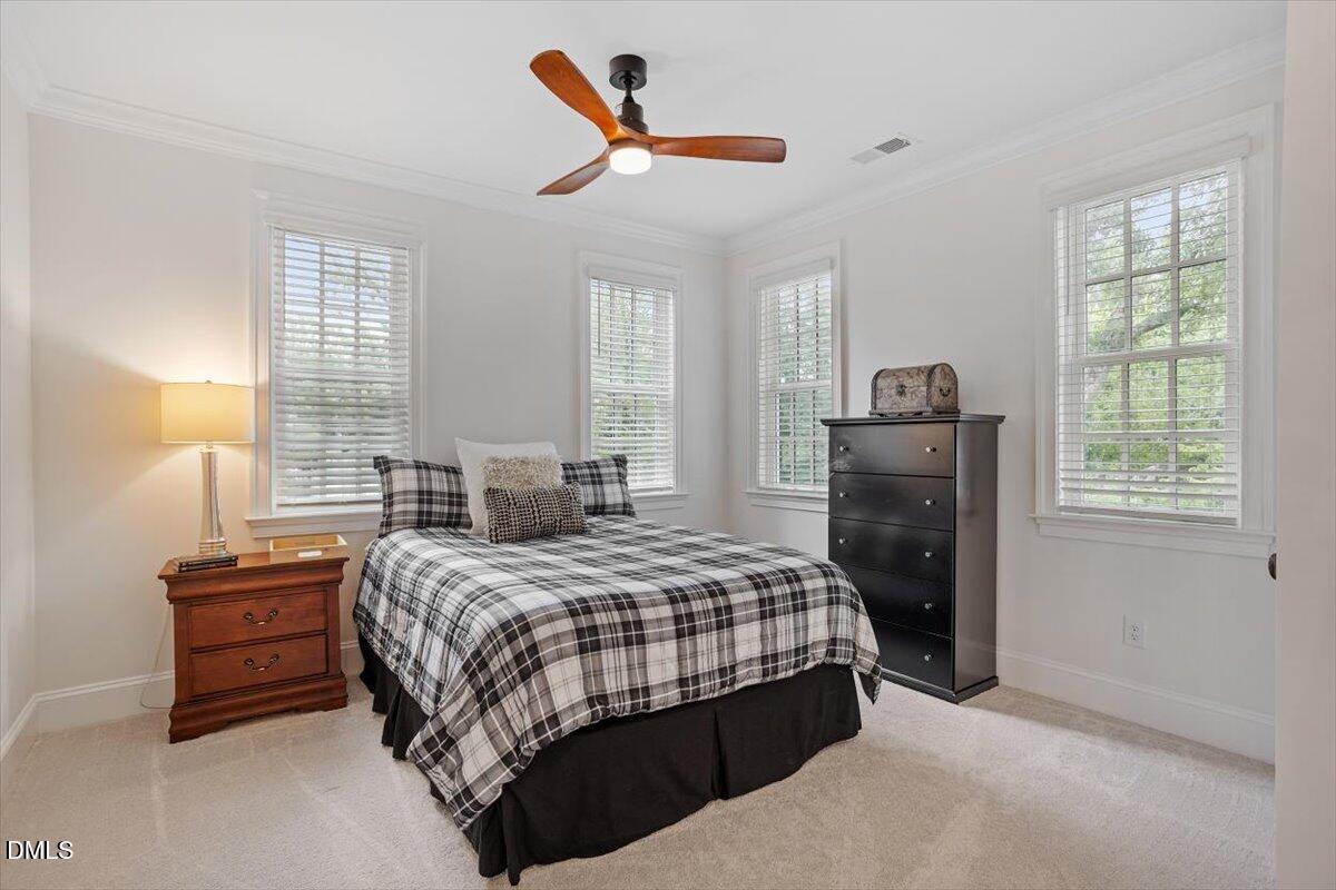 1713 Oberlin Road Raleigh, NC 27608 - Photo 38 of 53 a bedroom with a bed a window and a ceiling fan