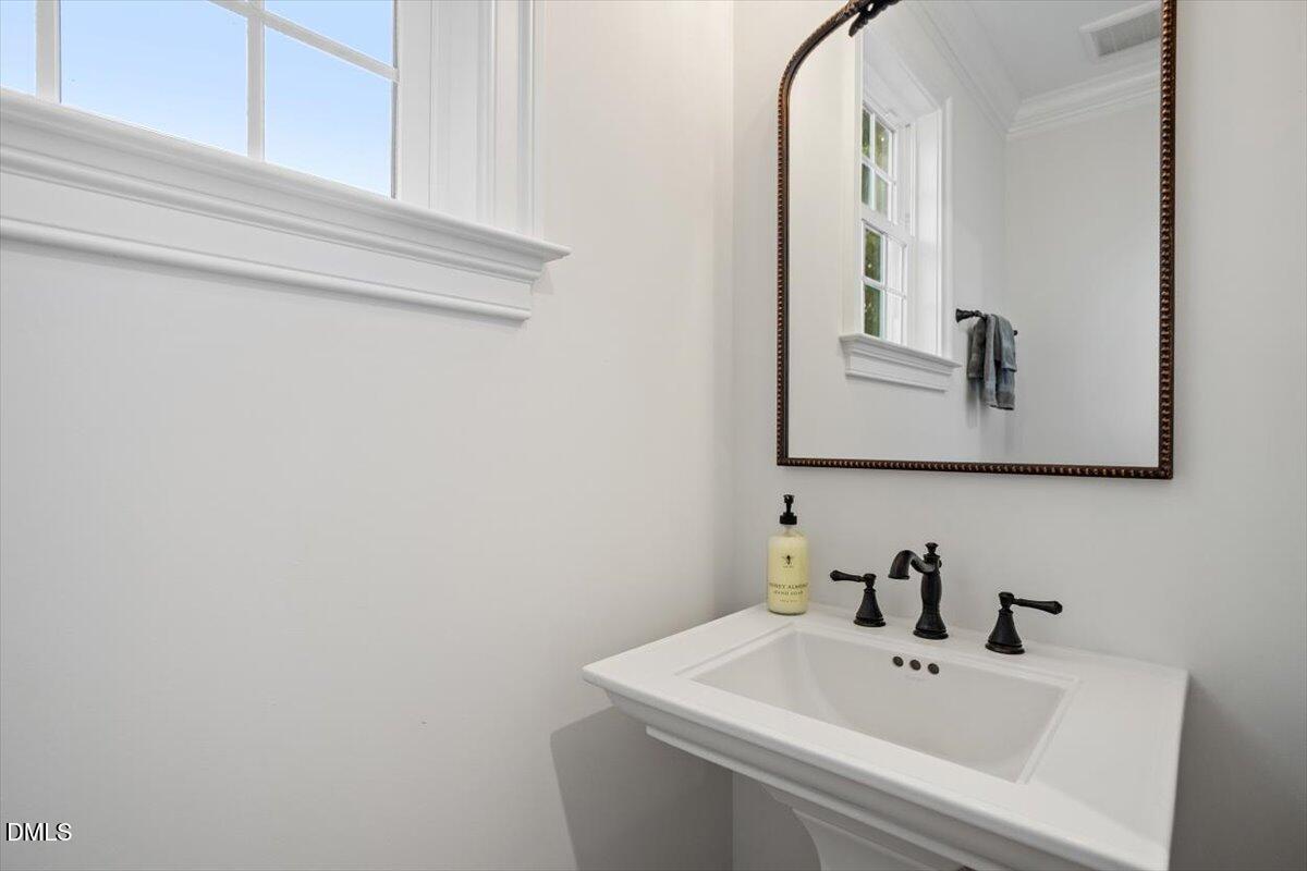 1713 Oberlin Road Raleigh, NC 27608 - Photo 41 of 53 a bathroom with a sink and a mirror