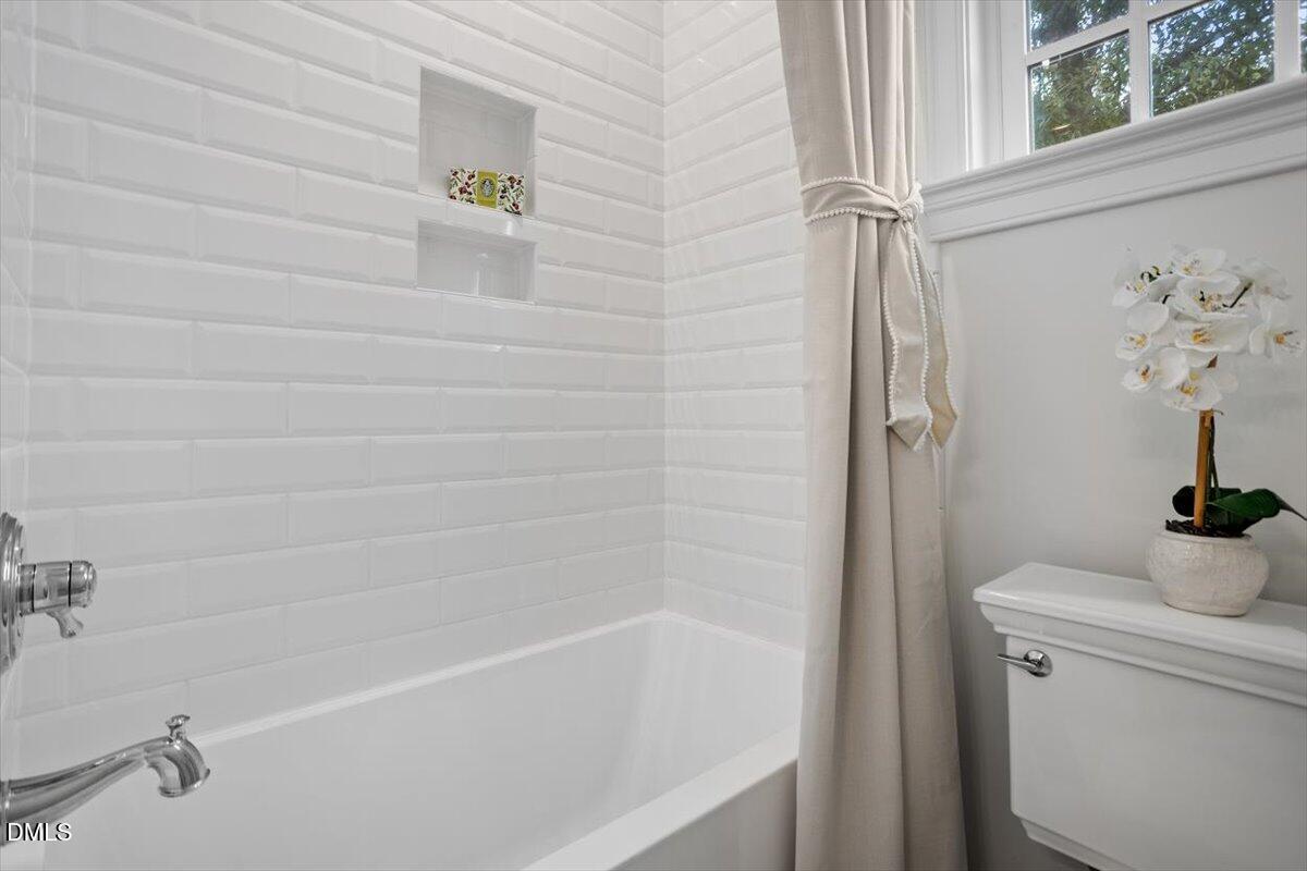 1713 Oberlin Road Raleigh, NC 27608 - Photo 43 of 53 a bathroom with a bathtub and shower