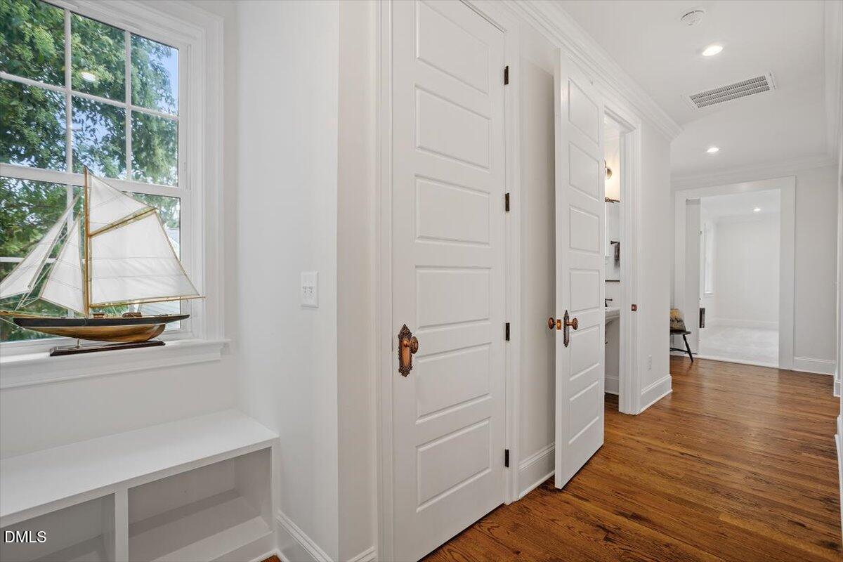 1713 Oberlin Road Raleigh, NC 27608 - Photo 44 of 53 a view of a hallway with wooden floor and windows