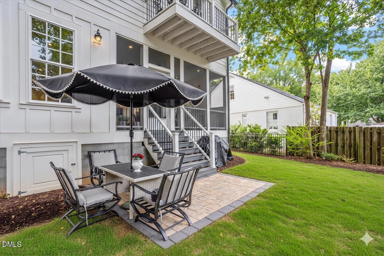 1713 Oberlin Road Raleigh, NC 27608 - Photo 52 of 53 a view of a backyard with table and chairs with wooden fence and plants
