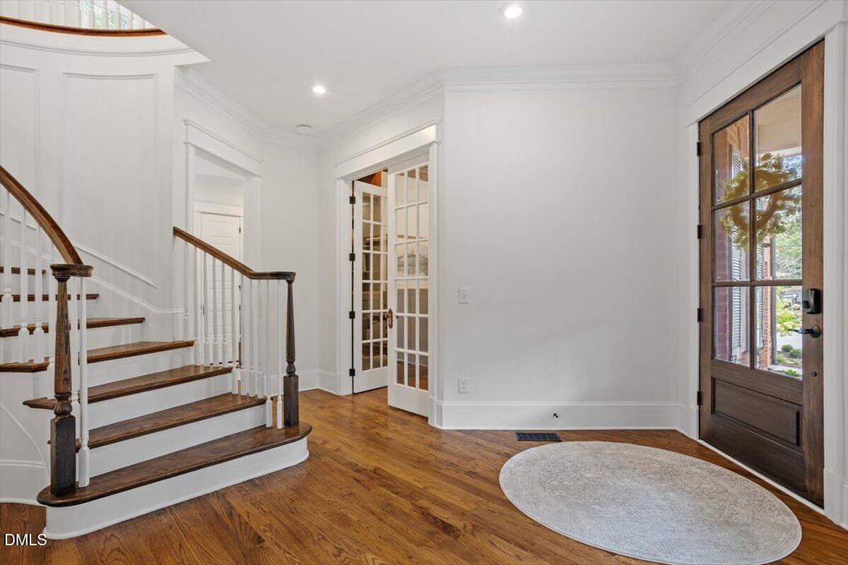 1713 Oberlin Road Raleigh, NC 27608 - Photo 7 of 53 a view of entryway with wooden floor and stairs