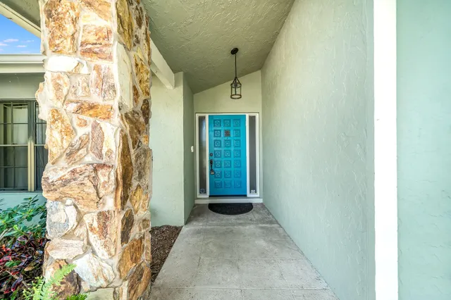 a view of a hallway with workspace and furniture