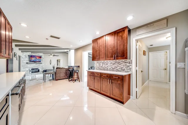 a kitchen with a refrigerator and white cabinets