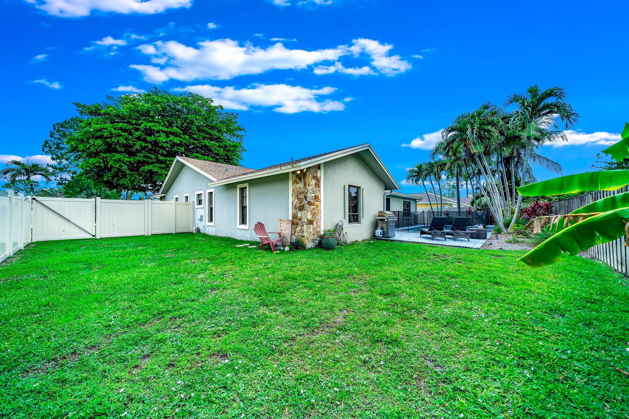 574 Juniper Place Wellington, FL 33414 - Photo 46 of 48 a view of a house with backyard and garden