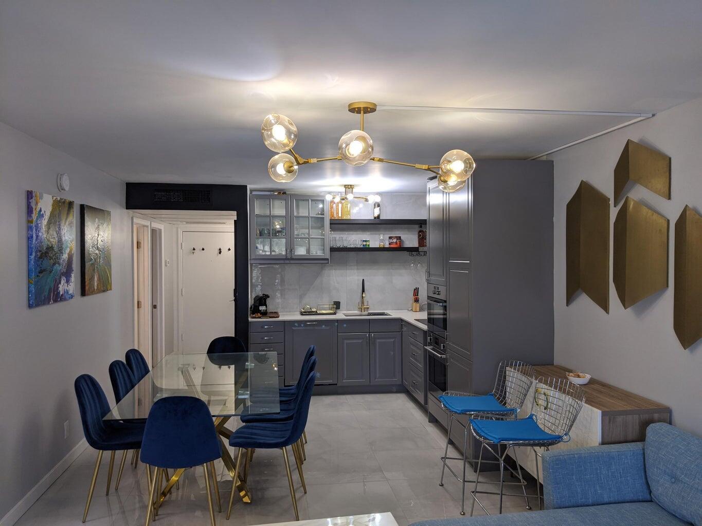 a kitchen with cabinets and chandelier