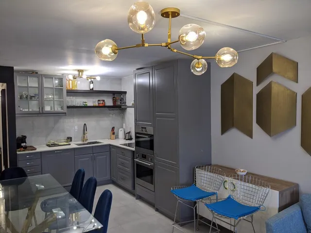 a kitchen with cabinets table and chairs