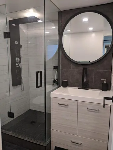a bathroom with a shower and a sink