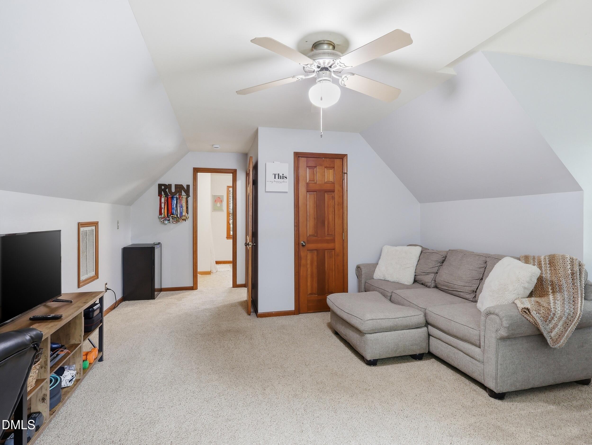 517 Lake Glad Road Wendell, NC 27591 - Photo 21 of 36 a living room with furniture and a flat screen tv