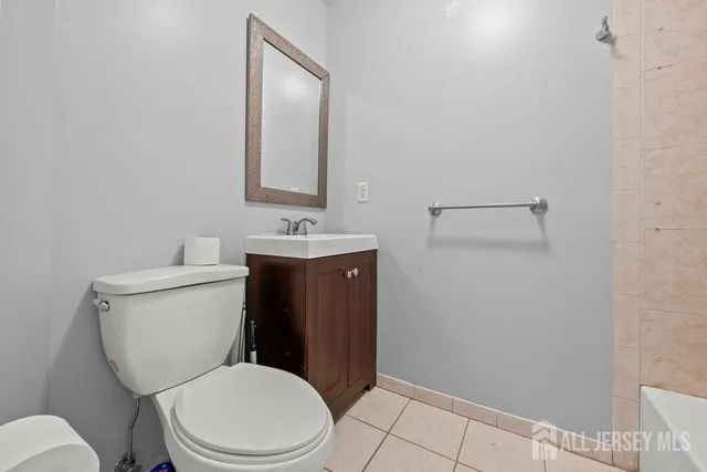 a white toilet sitting next to a bathroom sink
