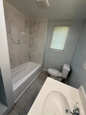 a bathroom with a bathtub and shower