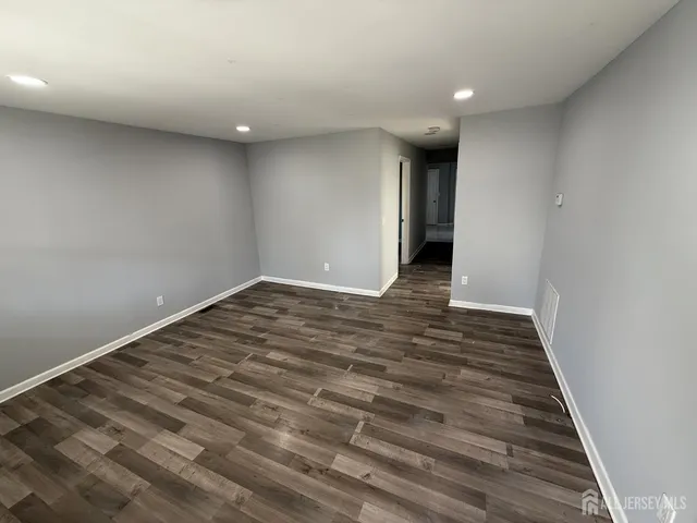 a view of hallway with wooden floor