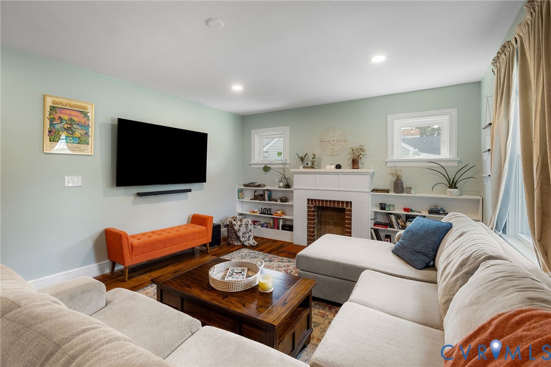 2519 Maplewood Road Henrico, VA 23228 - Photo 3 of 41 a living room with furniture a flat screen tv and kitchen view
