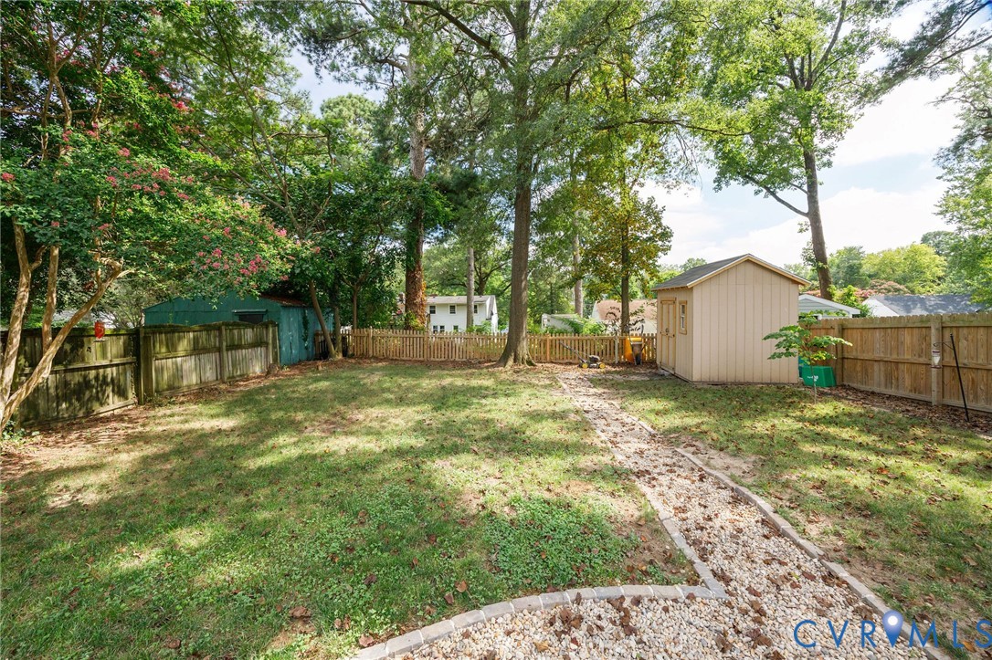2519 Maplewood Road Henrico, VA 23228 - Photo 41 of 41 a backyard of a house with table and chairs and a large tree